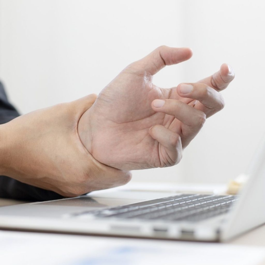 person holding wrist in pain