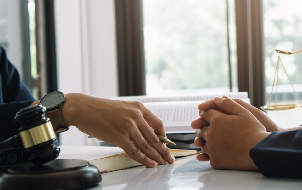 Lawyers talking at a desk