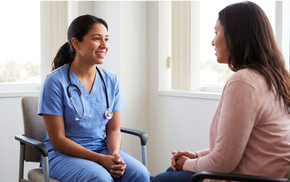 A nurse sitting and conversing with a professional advocate, showing an expression of relief.